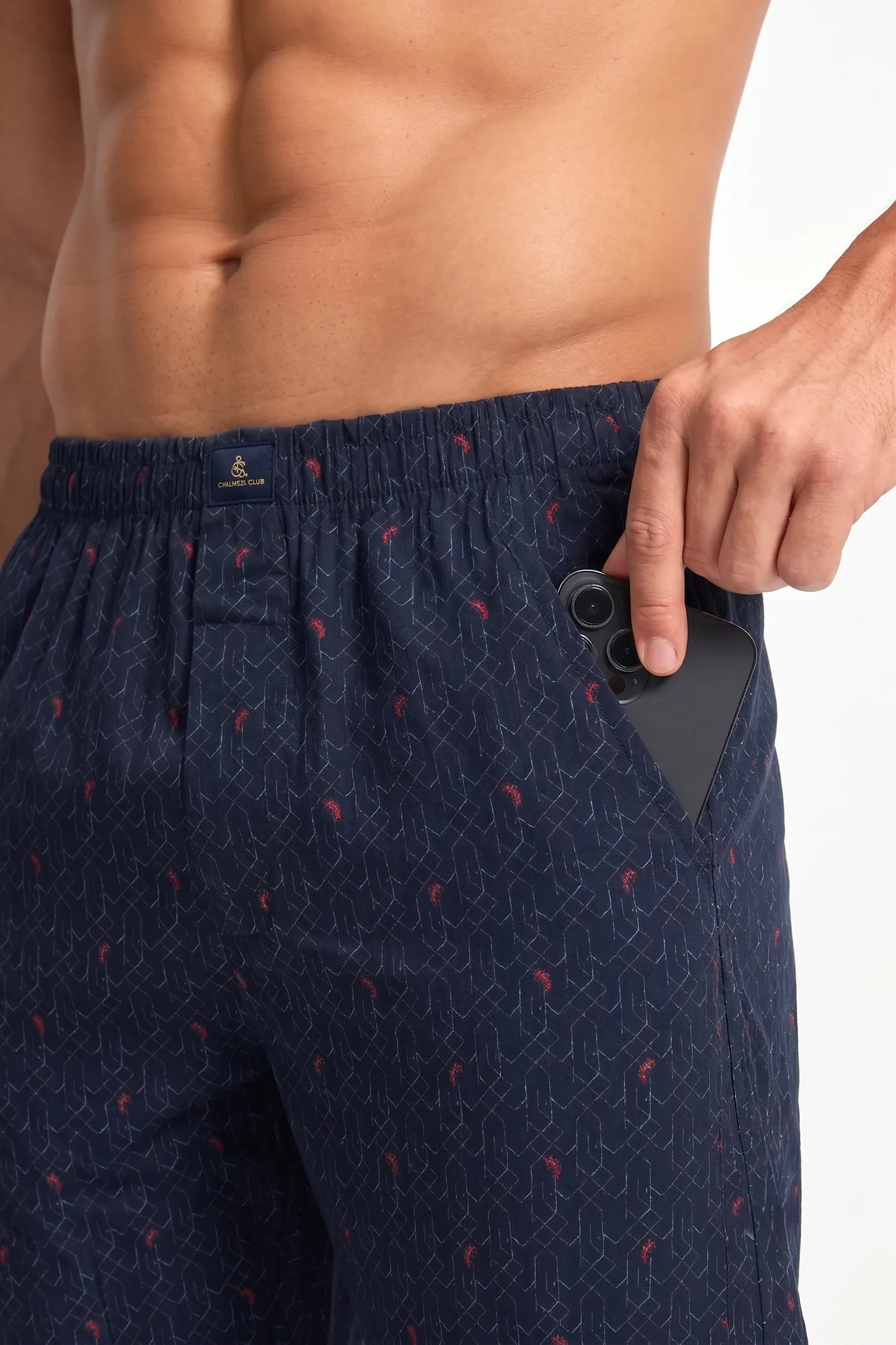 A phone sliding into the side pocket of Indigo Lattice boxer shorts, showing the pocket depth